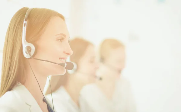 Smiling businesswoman or helpline operator with headset and computer at office — Stock Photo, Image