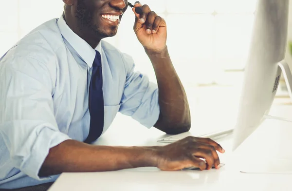 Homme d'affaires afro-américain sur casque de travail sur son ordinateur portable — Photo