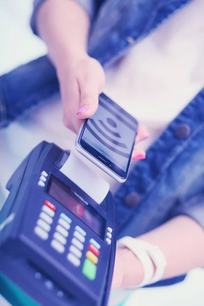 Customer is paying with smartphone in shop using NFC technology. NFC technology. Customer is paying — Stock Photo, Image