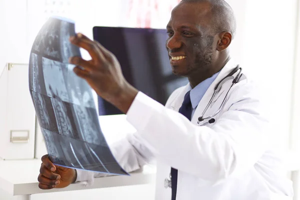 Portrait young african medical doctor holding patients x-ray — Stock Photo, Image