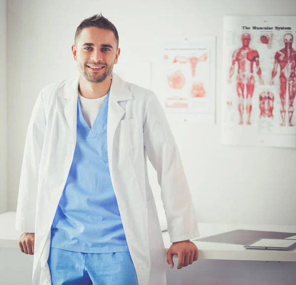 Young and confident male doctor portrait standing in medical office. — Stock Photo, Image