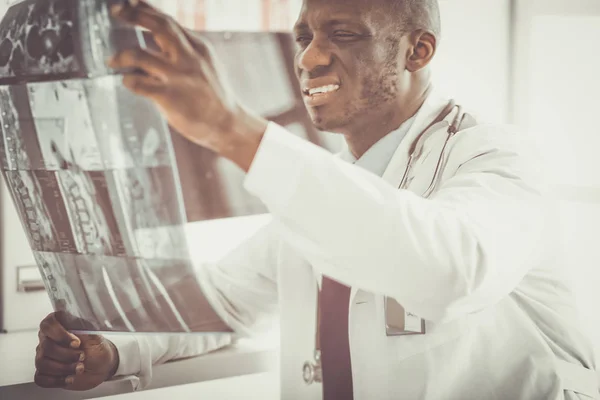 Portrait young african medical doctor holding patients x-ray — Stock Photo, Image