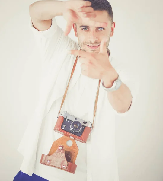 Young man with camera. Isolated over white background. — Stock Photo, Image