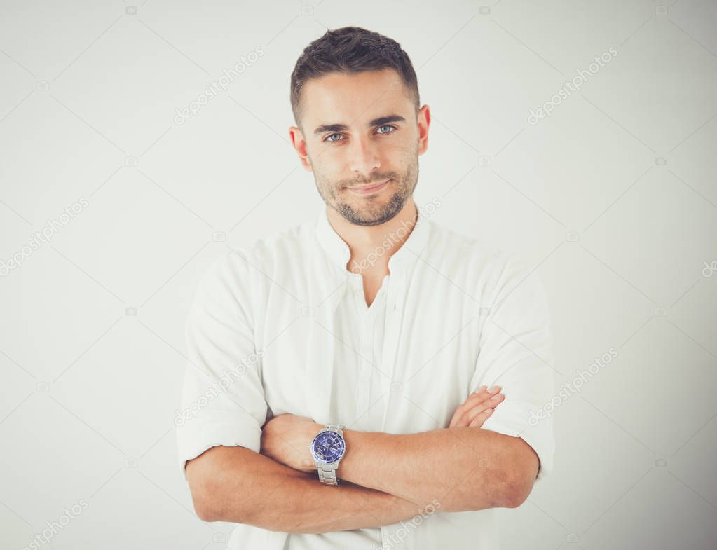 Young business man standing isolated on white background.