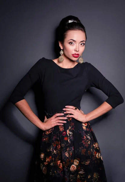 Retro woman portrait, standing on the black background