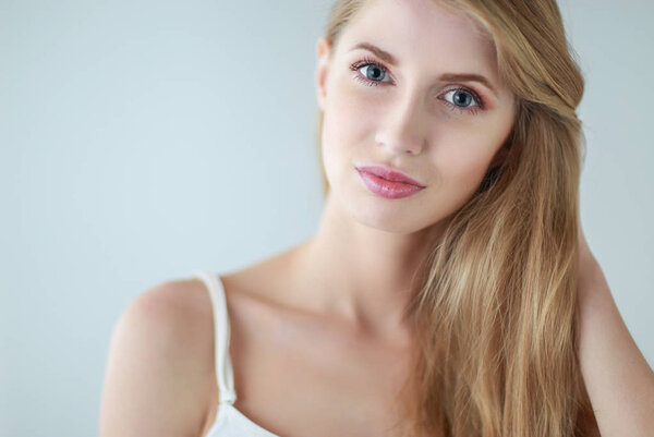 Portrait of beautiful woman isolated on gray background