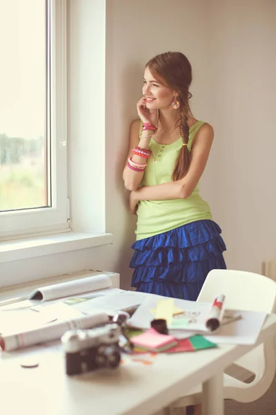 Portrait of a young beautiful photographer woman near table — Stock Photo, Image