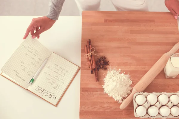 Portrait of young woman against kitchen interior background — Stock Photo, Image