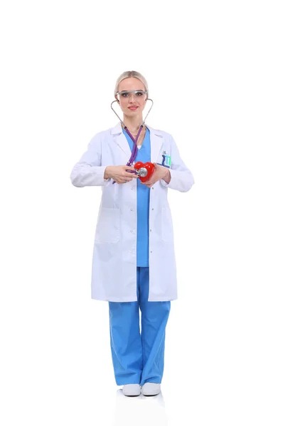 Young woman doctor holding a red heart, isolated on white background. Woman doctor — Stock Photo, Image