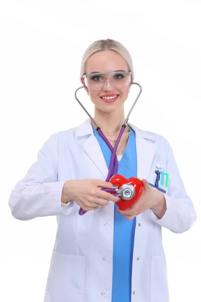 Young woman doctor holding a red heart, isolated on white background. Woman doctor — Stock Photo, Image