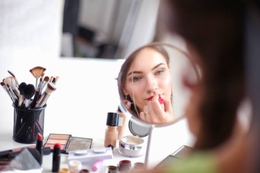 Genç güzel kadın ayna, Masa başında oturan yakınındaki makyaj yapma