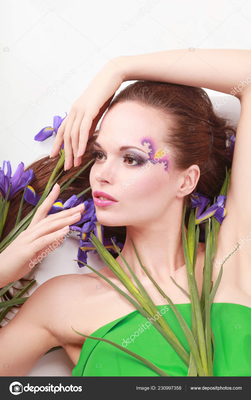 Beautiful young woman holding flowers on white background Stock Photo