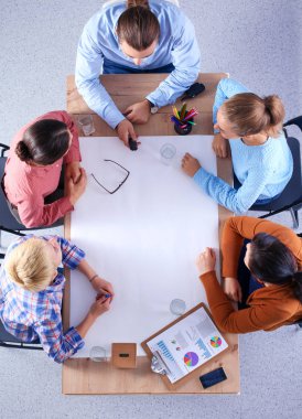 İş adamları toplantıda, ofiste oturup tartışıyorlar.