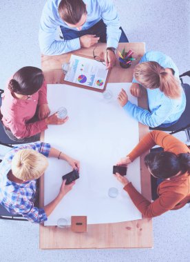 İş adamları toplantıda, ofiste oturup tartışıyorlar.