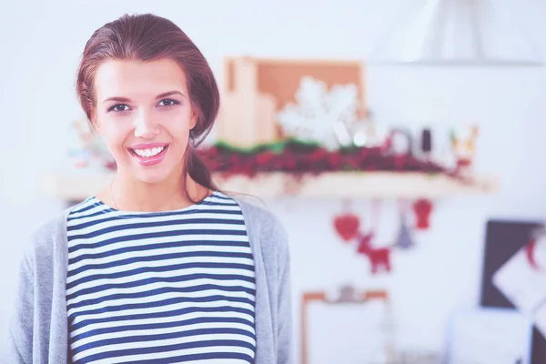Portrait of young woman against kitchen interior background — Stock Photo, Image