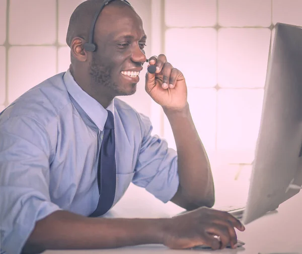 Homme d'affaires afro-américain sur casque de travail sur son ordinateur portable — Photo