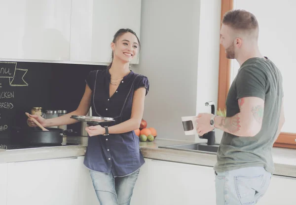 Couple cooking together in their kitchen at home — Stock Photo, Image