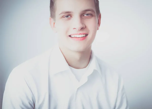 Portrait of young man smiling sitting on gray background. Portrait of young man — Stock Photo, Image