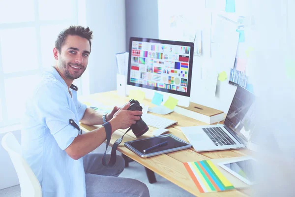 Portrait of young designer sitting at graphic studio in front of laptop and computer while working online. — Stock Photo, Image