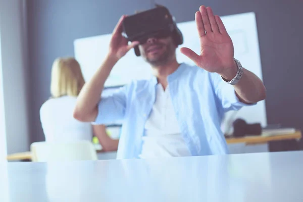 Young male software programmer testing a new app with 3d virtual reality glasses in office. — Stock Photo, Image