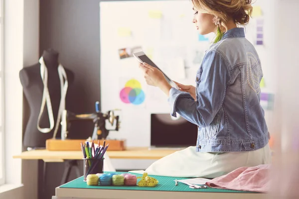 Donna stilista che lavora sui suoi disegni in studio — Foto Stock