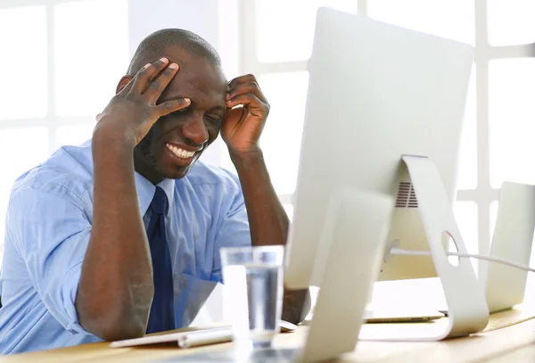 African american businessman on headset working on his laptop — Stock Photo, Image