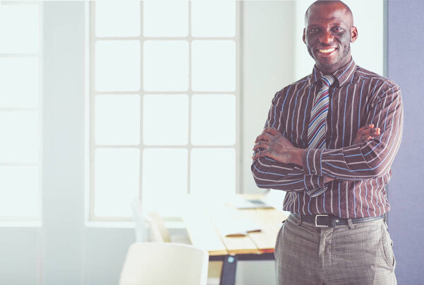 Portrait of an handsome black businessman standing in office