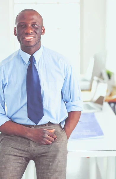 Portrait of an handsome black businessman standing in office — Stock Photo, Image