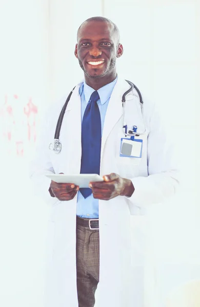 Male black doctor worker with tablet computer standing in hospital