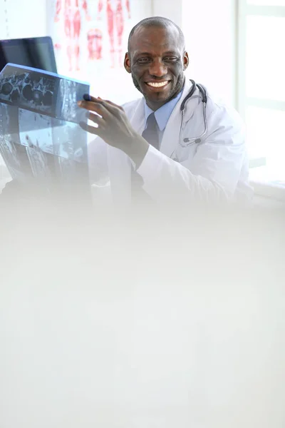 Portrait young african medical doctor holding patients x-ray — Stock Photo, Image