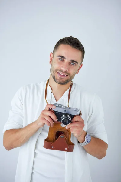 Young man with camera. Isolated over white background. — Stock Photo, Image