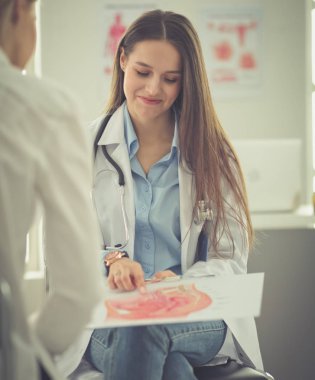 Doktor ve hasta masada otururken bir şey tartışıyorlar. İlaç ve sağlık hizmetleri kavramı