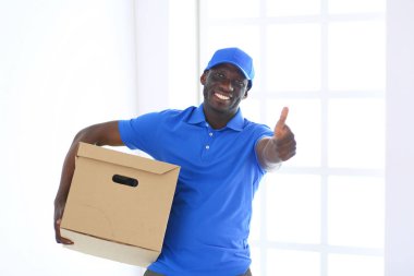 Portrait of an handsome happy deliverer with box clipart