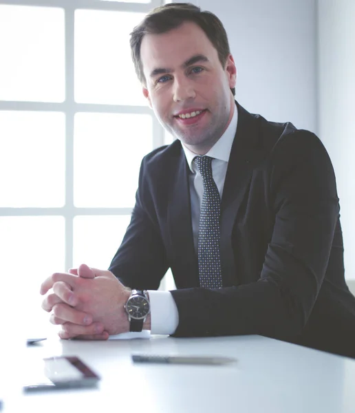 Portrait of young man sitting at his desk in the office. — Stock Photo, Image