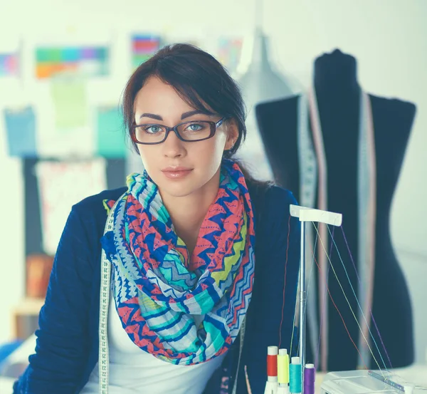 Beautiful young fashion designer standing in studio — Stock Photo, Image