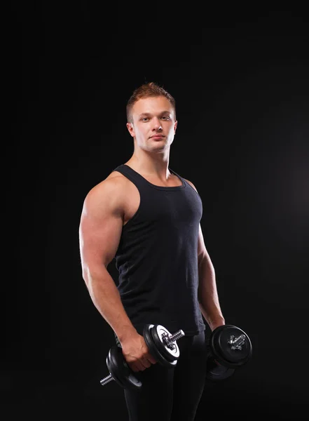 Handsome muscular man working out with dumbbells — Stock Photo, Image