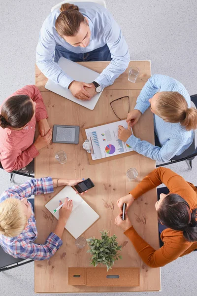 Business people sitting and discussing at meeting, in office — Stock Photo, Image