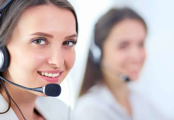 Smiling businesswoman or helpline operator with headset and computer at office — Stock Photo, Image