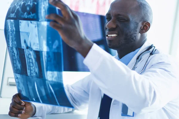 Portrait young african medical doctor holding patients x-ray — Stock Photo, Image