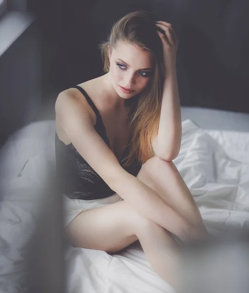 Yatakta seksi, şık bir kadın. — Stok fotoğraf