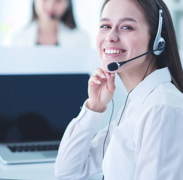 Smiling businesswoman or helpline operator with headset and computer at office — Stock Photo, Image