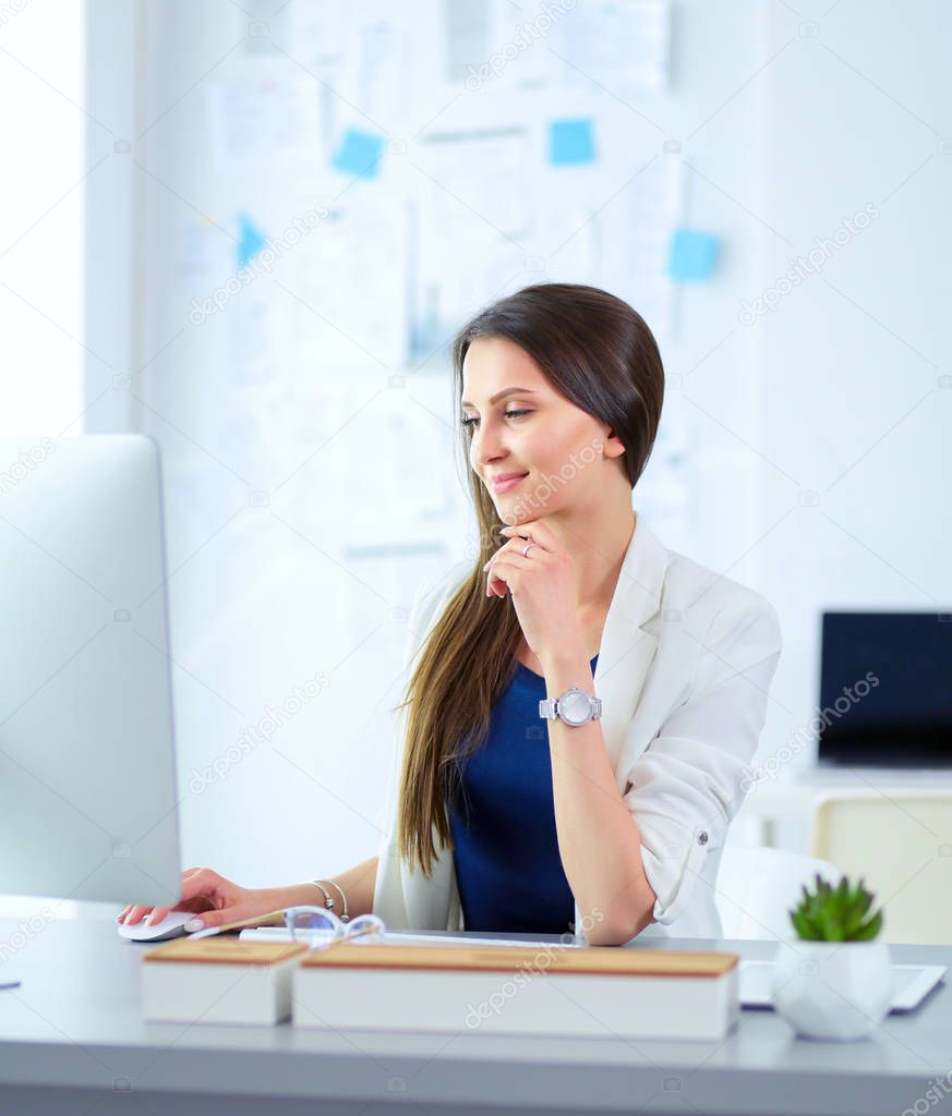 Attractive business woman working on laptop at office. Business people