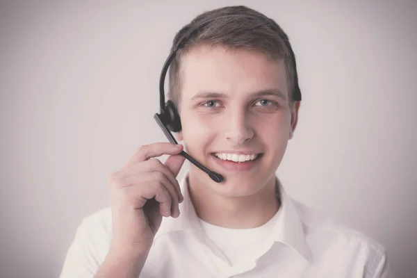 Portrait of young man smiling sitting on gray background. Portrait of young man — Stock Photo, Image