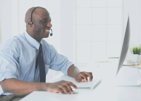 African american businessman on headset working on his laptop — Stock Photo, Image