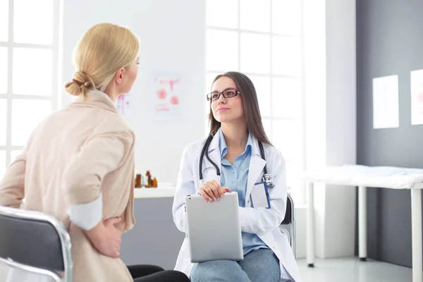 Doktorn och patienten diskuterar något när de sitter vid bordet. Medicin och hälsovård — Stockfoto