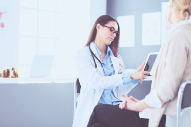 Doktor ve hasta masada otururken bir şey tartışıyorlar. İlaç ve sağlık hizmetleri kavramı