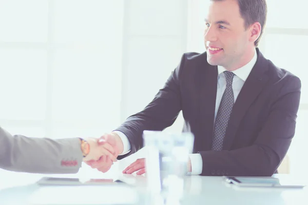 Porträt eines jungen Mannes, der an seinem Schreibtisch im Büro sitzt. — Stockfoto