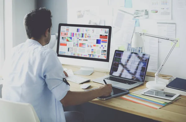 Portrait of young designer sitting at graphic studio in front of laptop and computer while working online. — Stock Photo, Image