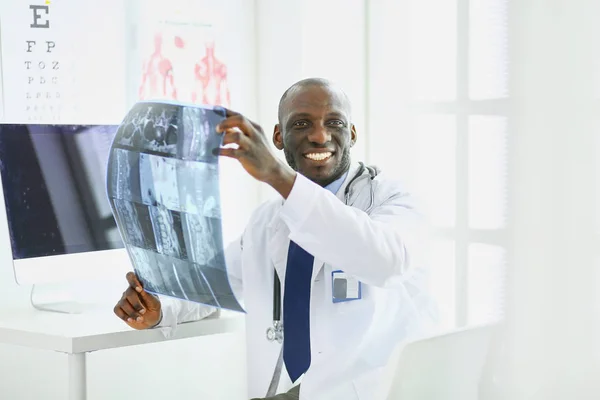 Portrait young african medical doctor holding patients x-ray — Stock Photo, Image