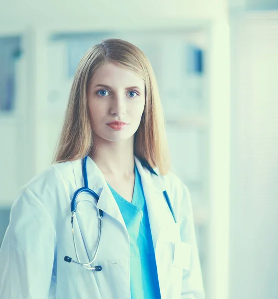 Doctor woman is standing in the near window — Stock Photo, Image